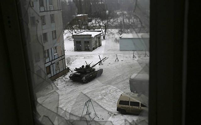 A Ukrainian military tank is stationed outside a building in the flashpoint eastern town of Avdiivka that sits just north of the pro-Russian rebels' de facto capital of Donetsk on February 2, 2017. (Aleksey Filippov/AFP)