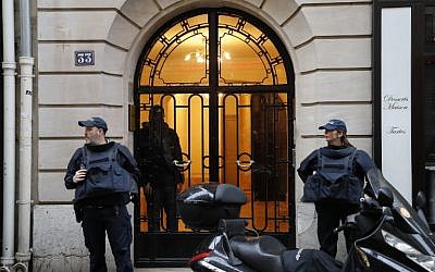 French police officers stand on a sidewalk as a search is conducted in Paris's 8th arrondissement as part of the investigation into the attack at the Louvre museum earlier on February 3, 2017. (AFP/Francois Guillot)