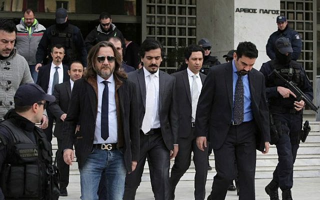 This file photo taken on January 23, 2017 shows Turkish officers being escorted by Greek special police forces as they leave the Greek Supreme Court in Athens, after a hearing concerning a possible extradition of the officers over July's failed coup in Turkey in Athens. (Angelos Tzortzinis/AFP)