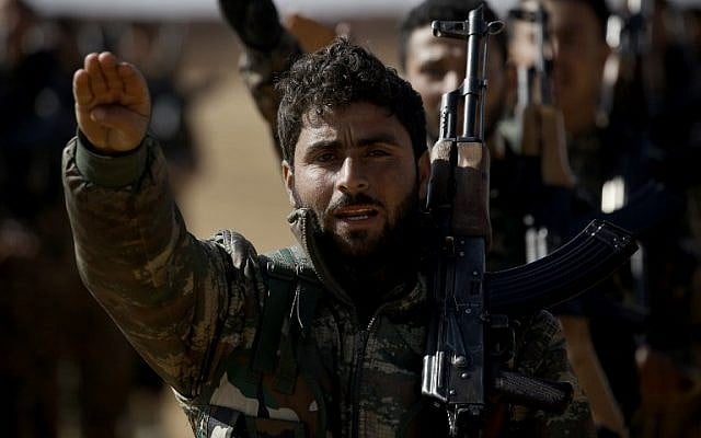Syrian Democratic Forces gather in the northern countryside of Raqqa for a briefing, to announce a new phase in their campaign for the Islamic State group's Syrian stronghold, on February 4, 2017. (AFP PHOTO / DELIL SOULEIMAN)