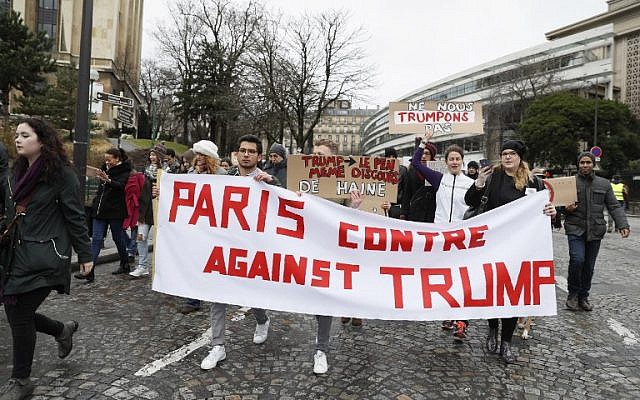 Anti-Trump protesters hold a banner reading 'Paris against Trump' during a demonstration against Trump's policies in Paris, February 4, 2017. (AFP/THOMAS SAMSON)