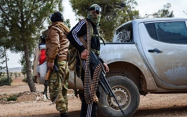 Two fighters from the Free Syrian Army stand next to an armored pickup truck, one carrying a machine gun, near the town of Bizaah northeast of the city of al-Bab, some 30 kilometers from Aleppo, on February 4, 2017. (AFP/Nazeer al-Khatib) Two fighters from the Free Syrian Army stand next to an armored pickup truck, one carrying a machine gun, near the town of Bizaah northeast of the city of al-Bab, some 30 kilometers from Aleppo, on February 4, 2017. (AFP/Nazeer al-Khatib)