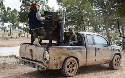 Fighters from the Free Syrian Army in an armoured pickup truck near the town of Bizaah northeast of the city of Al-Bab, some 30 kilometers from the Syrian city of Aleppo, on February 4, 2017. (AFP Photo/Nazeer al-Khatib)