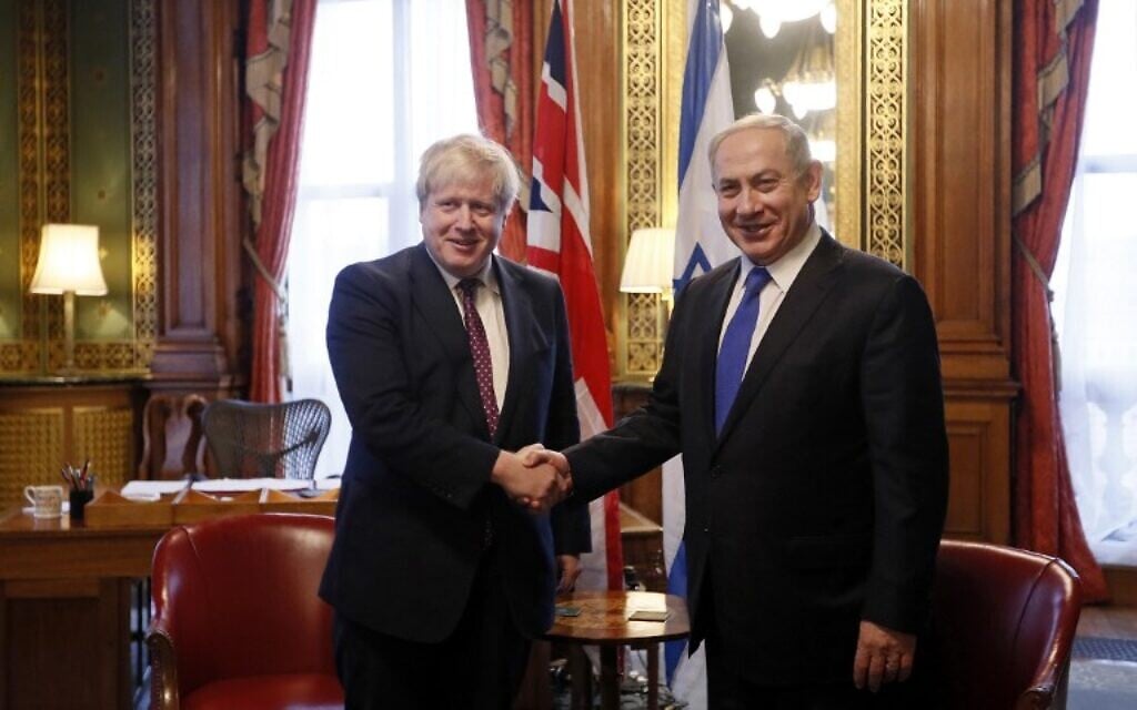 Britain's then-Foreign Secretary Boris Johnson (L) shakes hands with Prime Minister Benjamin Netanyahu at the UK Foreign Office in central London, February 6, 2017. Behind them is the desk on which Johnson claimed, falsely, that former UK Foreign Secretary Arthur Balfour which the Balfour Declaration in 1917. (AFP/Pool/Kirsty Wigglesworth) Britain's then-Foreign Secretary Boris Johnson (L) shakes hands with Prime Minister Benjamin Netanyahu at the UK Foreign Office in central London, February 6, 2017. Behind them is the desk on which Johnson claimed, falsely, that former UK Foreign Secretary Arthur Balfour which the Balfour Declaration in 1917. (AFP/Pool/Kirsty Wigglesworth)