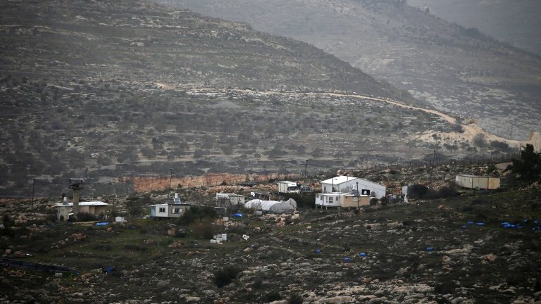 A picture taken on February 8, 2017 from the Palestinian West Bank village of Yasuf shows the Israeli wildcat outpost of Kfar Tapuah West, located near the settlement of Kfar Tapuah. (AFP Photo/Jaafar Ashtiyeh) A picture taken on February 8, 2017 from the Palestinian West Bank village of Yasuf shows the Israeli wildcat outpost of Kfar Tapuah West, located near the settlement of Kfar Tapuah. (AFP Photo/Jaafar Ashtiyeh)