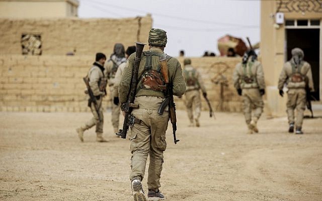 Members of the Syrian Democratic Forces, made up of US-backed Kurdish and Arab fighters, gather near the village of Bir Fawaz, north of Raqa, during their offensive towards the Islamic State (IS) group's Syrian stronghold, February 8, 2017. (AFP/DELIL SOULEIMAN)