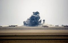 Illustrative: Smoke rises near the village of Bir Fawaz, north of Raqqa, as members of the Syrian Democratic Forces, made up of US-backed Kurdish and Arab fighters, advance during their offensive towards the Islamic State group's Syrian stronghold as part of the third phase to retake the city and its surroundings, February 8, 2017. (AFP/DELIL SOULEIMAN)