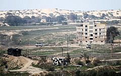 A picture taken from the southern Gaza Strip shows Egyptian soldiers patrolling the Egyptian side of the Rafah border crossing on February 9, 2017. (AFP/SAID KHATIB)