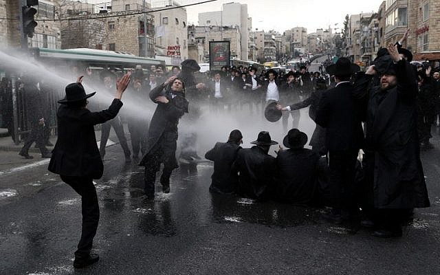 Police use water cannons on ultra-Orthodox men protesting IDF conscription in Jerusalem, on February 9, 2017. (AFP PHOTO/AHMAD GHARABLI)