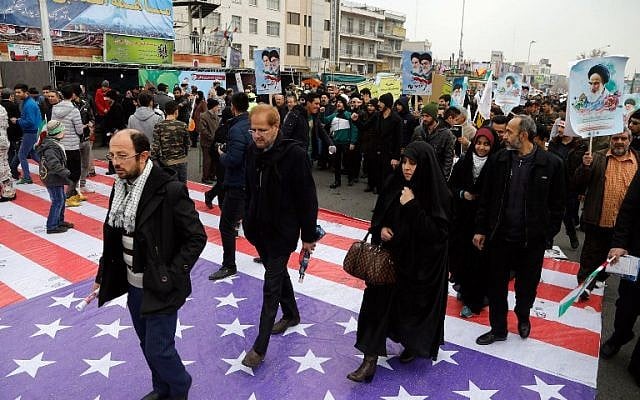Iranians step on a giant US flag as they take part in a rally marking the anniversary of the 1979 Islamic revolution on February 10, 2017, in the capital Tehran. Millions of Iranians marched on the anniversary day in what President Hassan Rouhani described as a response to the new US administration and a rejection of "threatening language". (Atta Kenare/AFP) Iranians step on a giant US flag as they take part in a rally marking the anniversary of the 1979 Islamic revolution on February 10, 2017, in the capital Tehran. Millions of Iranians marched on the anniversary day in what President Hassan Rouhani described as a response to the new US administration and a rejection of "threatening language". (Atta Kenare/AFP)