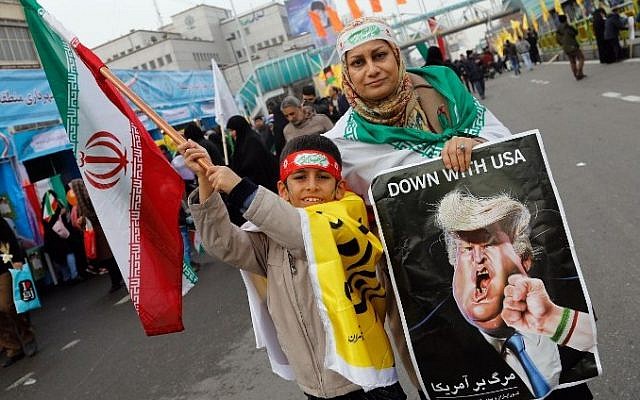 An Iranian woman holds a placard showing a caricature of US President Donald Trump being punched by a hand wearing a bracelet of the Iranian flag during a rally marking the anniversary of the 1979 Islamic revolution on February 10, 2017, in the capital Tehran. (Atta Kenare/AFP) An Iranian woman holds a placard showing a caricature of US President Donald Trump being punched by a hand wearing a bracelet of the Iranian flag during a rally marking the anniversary of the 1979 Islamic revolution on February 10, 2017, in the capital Tehran. (Atta Kenare/AFP)