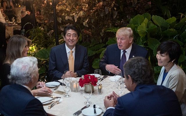 US President Donald Trump, center, Japanese Prime Minister Shinzo Abe (2nd left), his wife Akie Abe (right), US First Lady Melania Trump (Left) and Robert Kraft (foreground), sit down for dinner at Trump's Mar-a-Lago resort on February 10, 2017. (AFP / NICHOLAS KAMM) US President Donald Trump, center, Japanese Prime Minister Shinzo Abe (2nd left), his wife Akie Abe (right), US First Lady Melania Trump (Left) and Robert Kraft (foreground), sit down for dinner at Trump's Mar-a-Lago resort on February 10, 2017. (AFP / NICHOLAS KAMM)