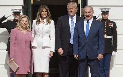 US President Donald Trump and First Lady Melania Trump greet Prime Minister Benjamin Netanyahu and his wife, Sara, as they arrive at the White House in Washington, DC, February 15, 2017. (AFP/Saul Loeb)