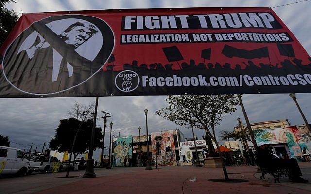 An anti-Trump banner outside the J&F Ice Cream store, which closed for the day in solidarity with the 'Day Without Immigrants' nationwide protests, in Los Angeles, California, on February 16, 2017. Scores of restaurants across the US shut down as part of the opposition to Donald Trump's treatment of immigrants. (AFP PHOTO/Mark RALSTON)
