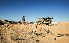 Fighters of the Hashed al-Shaabi (Popular Mobilisation) paramilitaries sit in a heavily-armed vehicle near defensive positions on the outskirts of Tal Afar west of Mosul, where Iraqi forces are preparing for the offensive retake the western side of Mosul from Islamic State (IS) group fighters, on February 18, 2017. ( AFP PHOTO / AHMAD AL-RUBAYE)