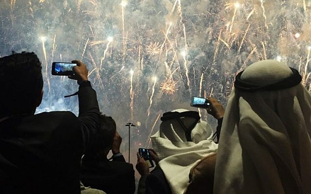 People take pictures of fireworks during the inauguration ceremony of the Trump International Golf Club in Dubai on February 18, 2017. (AFP PHOTO/Natacha YAZBECK)