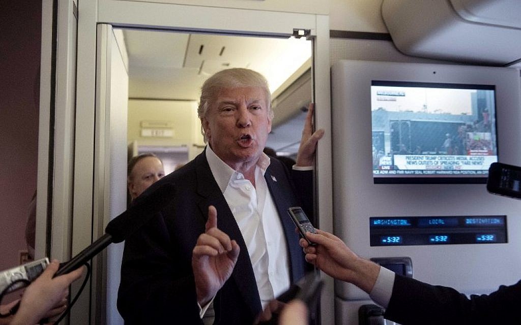 US President Donald Trump speaks to the press aboard Air Force One before addressing a rally in Melbourne, Florida, on February 18, 2017 (AFP PHOTO / NICHOLAS KAMM)