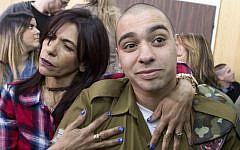 IDF soldier Elor Azaria, right, convicted on the manslaughter of a wounded Palestinian, is embraced by his mother Oshra at the start of his sentencing hearing in a military court in Tel Aviv, February 21, 2017. (AFP/POOL/ JIM HOLLANDER)