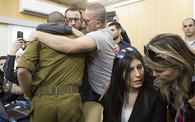 Israeli soldier Elor Azaria, who shot dead a wounded Palestinian assailant in March 2016, is embraced by family and friends at the start of his sentencing hearing in a military court in Tel Aviv on February 21, 2017. (AFP/ POOL / JIM HOLLANDER) Israeli soldier Elor Azaria, who shot dead a wounded Palestinian assailant in March 2016, is embraced by family and friends at the start of his sentencing hearing in a military court in Tel Aviv on February 21, 2017. (AFP/ POOL / JIM HOLLANDER)