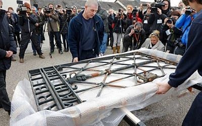 Workers unpack the original iron gate with the slogan 'Arbeit macht frei' ('Work will set you free') over the grounds of the former Nazi concentration camp in Dachau, southern Germany, February 22, 2017. (AFP Photo/Uwe Lein) Workers unpack the original iron gate with the slogan 'Arbeit macht frei' ('Work will set you free') over the grounds of the former Nazi concentration camp in Dachau, southern Germany, February 22, 2017. (AFP Photo/Uwe Lein)