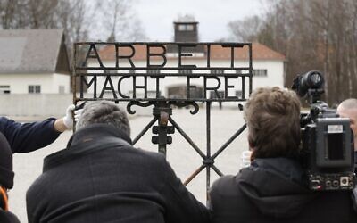 Journalists take pictures of the original iron gate with the slogan 'Arbeit macht frei' ('Work will set you free') at the former Nazi concentration camp in Dachau, southern Germany, on February 22, 2017. (AFP Photo/Uwe Lein)