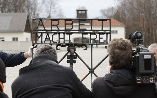 Journalists take pictures of the original iron gate with the slogan 'Arbeit macht frei' ('Work will set you free') at the former Nazi concentration camp in Dachau, southern Germany, on February 22, 2017. (AFP Photo/Uwe Lein) Journalists take pictures of the original iron gate with the slogan 'Arbeit macht frei' ('Work will set you free') at the former Nazi concentration camp in Dachau, southern Germany, on February 22, 2017. (AFP Photo/Uwe Lein)