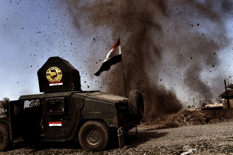 An explosion hits near a vehicle belonging to Iraq's elite Rapid Response Division during the assault to retake the northern city of Mosul, as Iraqi forces continue the offensive to retake the city's western half from IS, on February 25, 2017. (AFP/Aris Messinis) An explosion hits near a vehicle belonging to Iraq's elite Rapid Response Division during the assault to retake the northern city of Mosul, as Iraqi forces continue the offensive to retake the city's western half from IS, on February 25, 2017. (AFP/Aris Messinis)