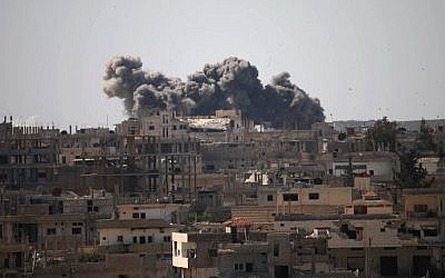 Smoke billows from buildings following reported air strikes on a rebel-held area in the southern city of Daraa, on February 25, 2017. (AFP Photo/Mohamad Abazeed)