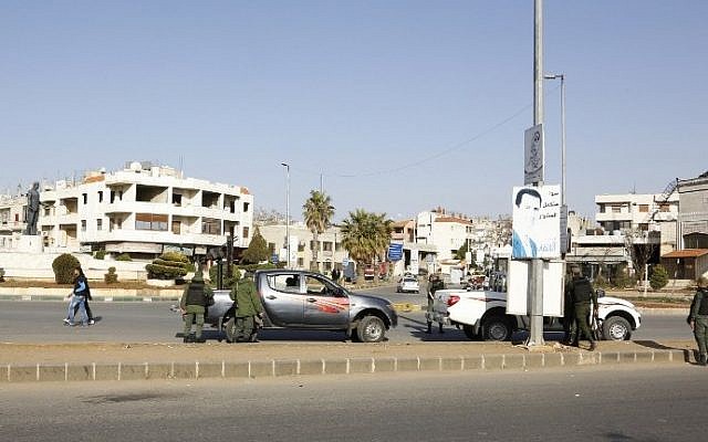 Illustrative: Syrian government forces man a checkpoint at the President Square in Homs on February 25, 2017, as security measures were tightened following a number of suicide attacks. (AFP Photo/Stringer) Illustrative: Syrian government forces man a checkpoint at the President Square in Homs on February 25, 2017, as security measures were tightened following a number of suicide attacks. (AFP Photo/Stringer)