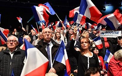 Supporters of the French far-right National Front (FN) party wave French flags during a campaign rally the presidential election, on February 26, 2017, at the Zenith de Nantes venue in Saint-Herblain. (AFP Photo/Jean-Francois Monier)