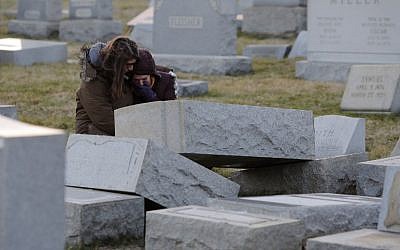 Melanie Steinhardt comforts Becca Richman at the Jewish Mount Carmel Cemetery, February 26, 2017, in Philadelphia. (AFP/Dominick Reuter)