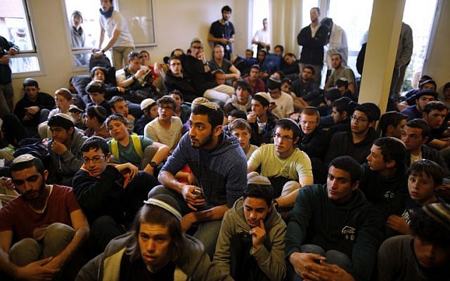 Young right-wing activists sit inside a house which is due to be evicted and demolished in the West Bank settlement of Ofra, on February 28, 2017. (Menahem Kahana/AFP Photo)