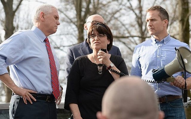 Anita Feigenbaum, executive director at Chesed Shel Emeth Cemetery speaks to the crowd on February 22, 2017 in University City, Missouri. Governor Eric Greitens (R) and US Vice President Mike Pence (L) were on hand to speak to over 300 volunteers who helped cleanup after the recent vandalism. (Michael Thomas/Getty Images/AFP Photo) Anita Feigenbaum, executive director at Chesed Shel Emeth Cemetery speaks to the crowd on February 22, 2017 in University City, Missouri. Governor Eric Greitens (R) and US Vice President Mike Pence (L) were on hand to speak to over 300 volunteers who helped cleanup after the recent vandalism. (Michael Thomas/Getty Images/AFP Photo)