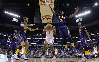 Trevor Ariza #1 of the Houston Rockets drives against Dante Cunningham #33 of the New Orleans Pelicans and Omri Casspi #18 during the second half of a game at the Smoothie King Center on February 23, 2017, in New Orleans, Louisiana. (Jonathan Bachman/Getty Images/AFP)