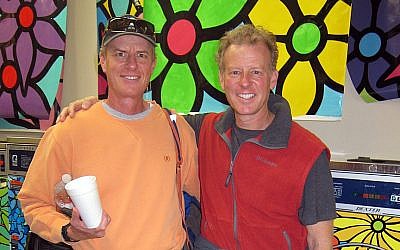 Bernie (left) and Ed Massey, co-founders of Portraits of Hope, in a laundromat with machines laminated in art by Portraits of Hope. (Laura Paresky Gould)