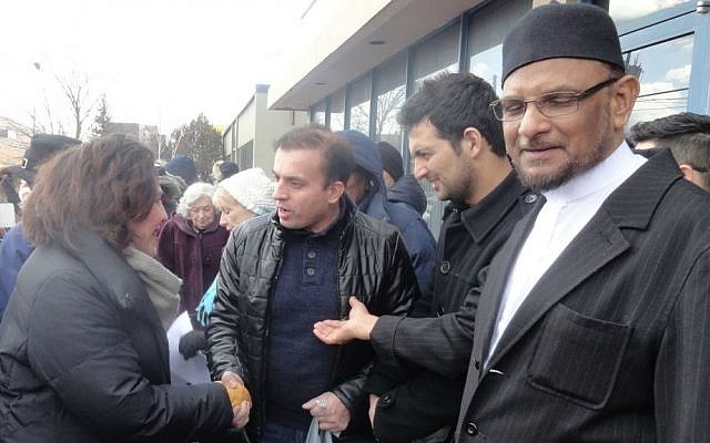 Holy Blossom Temple's Rabbi Yael Splansky (left) greets Imdadul Islamic Centre congregants as they exit prayers. Toronto, Canada. February 3, 2017. (Facebook/Holy Blossom Temple)