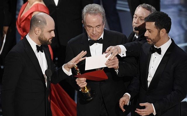 "La La Land" producer Jordan Horowitz, left, presenter Warren Beatty, center, and host Jimmy Kimmel right, look at an envelope announcing "Moonlight" as best picture at the Oscars on Sunday, Feb. 26, 2017, at the Dolby Theatre in Los Angeles. (Chris Pizzello/Invision/AP) "La La Land" producer Jordan Horowitz, left, presenter Warren Beatty, center, and host Jimmy Kimmel right, look at an envelope announcing "Moonlight" as best picture at the Oscars on Sunday, Feb. 26, 2017, at the Dolby Theatre in Los Angeles. (Chris Pizzello/Invision/AP)