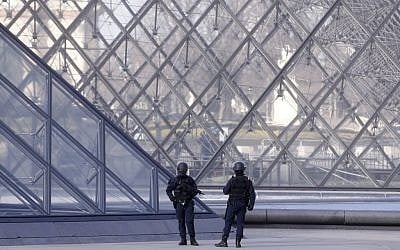 Police officers patrol at the pyramid outside the Louvre museum in Paris,Friday, Feb. 3, 2017. (AP Photo/Thibault Camus)
