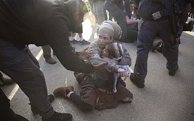 Israeli police with settlers from the West Bank settlement of Ofra, following the evacuation of Amona outpost, Thursday, Feb. 2, 2017. (AP Photo/Oded Balilty)