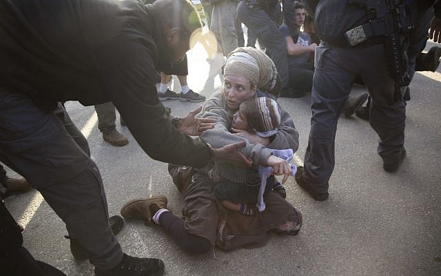 Israeli police with settlers from the West Bank settlement of Ofra, following the evacuation of Amona outpost, Thursday, Feb. 2, 2017. (AP Photo/Oded Balilty) Israeli police with settlers from the West Bank settlement of Ofra, following the evacuation of Amona outpost, Thursday, Feb. 2, 2017. (AP Photo/Oded Balilty)