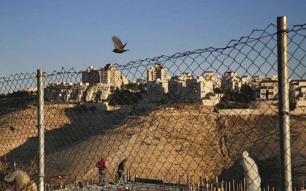 Palestinian laborers work at a construction site in a new housing project in the Israeli settlement of Maale Adumim, near Jerusalem, February 7, 2017.  (AP Photo/Oded Balilty)