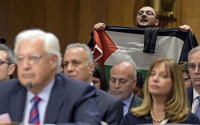A protestor, holding a Palestinian flag, interrupts David Friedman, nominated to be US Ambassador to Israel, as he testifies on Capitol Hill in Washington, Thursday, Feb. 16, 2017, at his confirmation hearing before the Senate Foreign Relations Committee. (AP Photo/Susan Walsh) A protestor, holding a Palestinian flag, interrupts David Friedman, nominated to be US Ambassador to Israel, as he testifies on Capitol Hill in Washington, Thursday, Feb. 16, 2017, at his confirmation hearing before the Senate Foreign Relations Committee. (AP Photo/Susan Walsh)