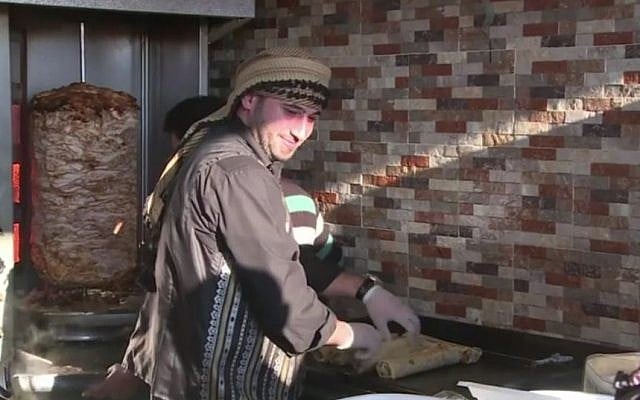 Syrian refugee Anas Qaterji serves shawarma in his restaurant in Gaza 2017 (Screen capture: YouTube) Syrian refugee Anas Qaterji serves shawarma in his restaurant in Gaza 2017 (Screen capture: YouTube)