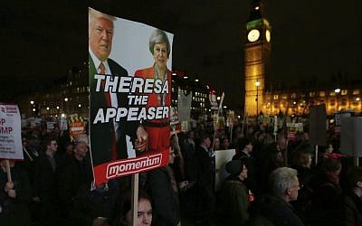 Demonstrators hold placards as they listen to speeches on February 20, 2017, in London, during a rally in Parliament Square opposing US President Donald Trump's planned state visit to the United Kingdom. (AP Photo/Tim Ireland)
