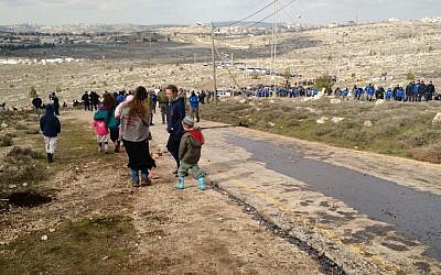 Amona parents sending their kids down the hill ahead of the evacuation, February 1, 2017 (Judah Ari Gross/Times of Israel) Amona parents sending their kids down the hill ahead of the evacuation, February 1, 2017 (Judah Ari Gross/Times of Israel)