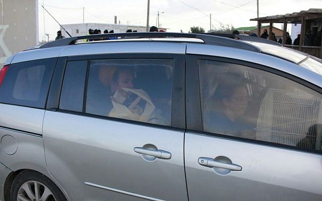 Residents leaving Amona with at least two Torah scrolls, February 1, 2017. (Judah Ari Gross/Times of Israel)