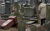 People walk through toppled graves at Chesed Shel Emeth Cemetery in University City, Missouri, on February 21, 2017. (Robert Cohen /St. Louis Post-Dispatch via AP)