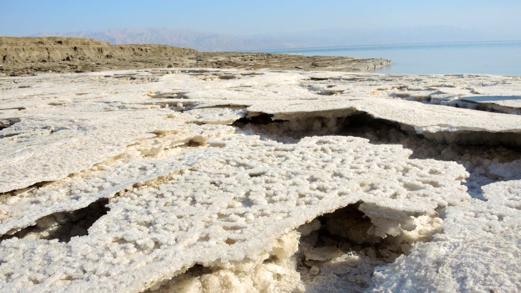 The receding shore line leaves a thin crust of salt behind as the water level of the Dead Sea drops more than a meter a year, like this area pictured on January 11, 2017. (Melanie Lidman/Times of Israel) The receding shore line leaves a thin crust of salt behind as the water level of the Dead Sea drops more than a meter a year, like this area pictured on January 11, 2017. (Melanie Lidman/Times of Israel)