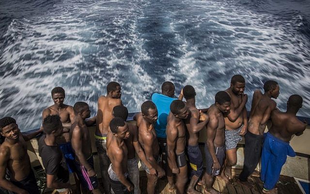 Refugees and migrants rest aboard Golfo Azurro, the Spanish NGO Proactiva Open Arms rescue ship, after being rescued from a boat out of control at 25 miles north of Sabratha, off the Libyan coast, early in the morning on February 23, 2016. (AP Photo/Santi Palacios)