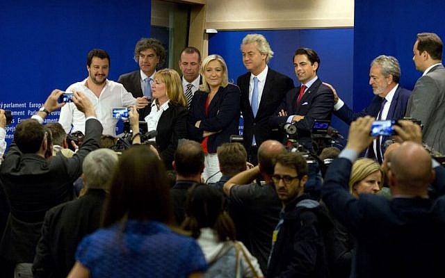 In this June 16, 2015, file photo, French far right leader of the Front National, Marine Le Pen, center, poses with other members of the far right after a media conference at the European Parliament in Brussels. (AP Photo/Virginia Mayo, File)